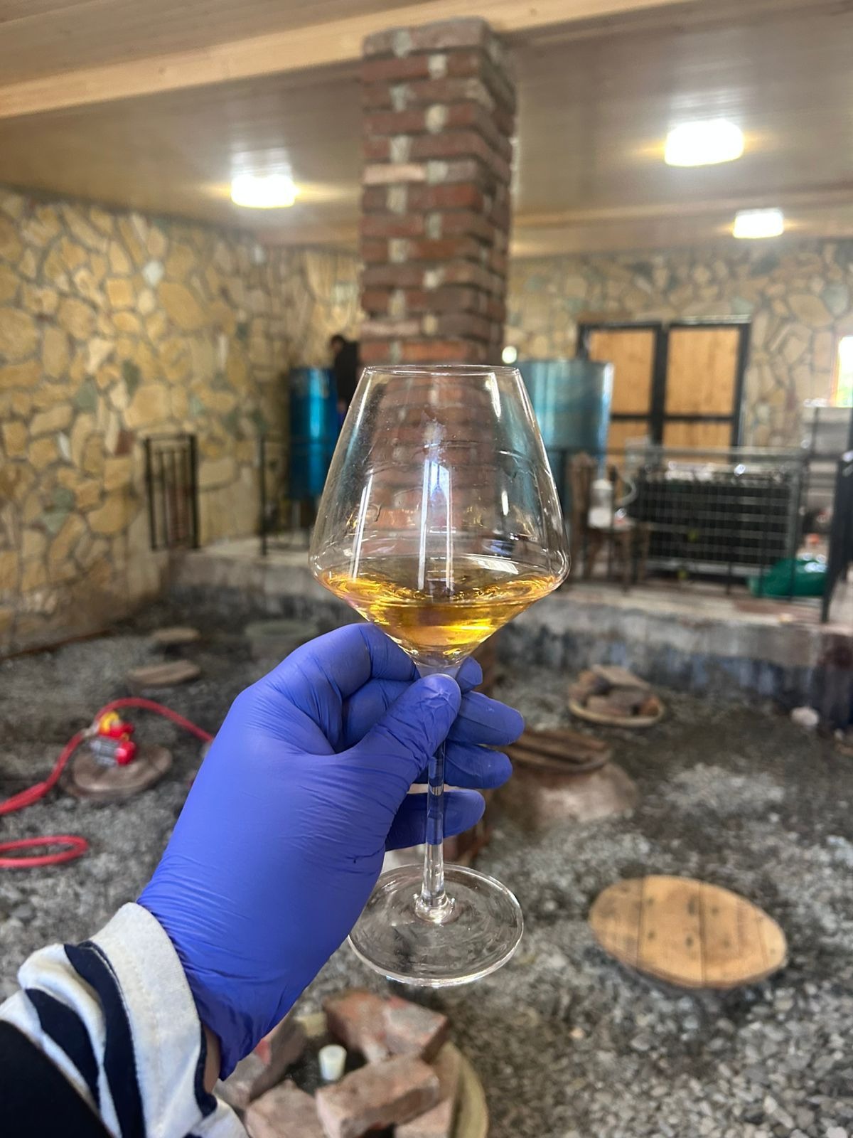 Amber wine in a glass inside the cellar