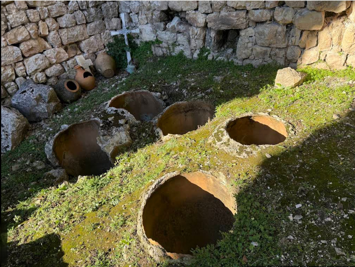 Traditional qvevri buried in a stone cellar