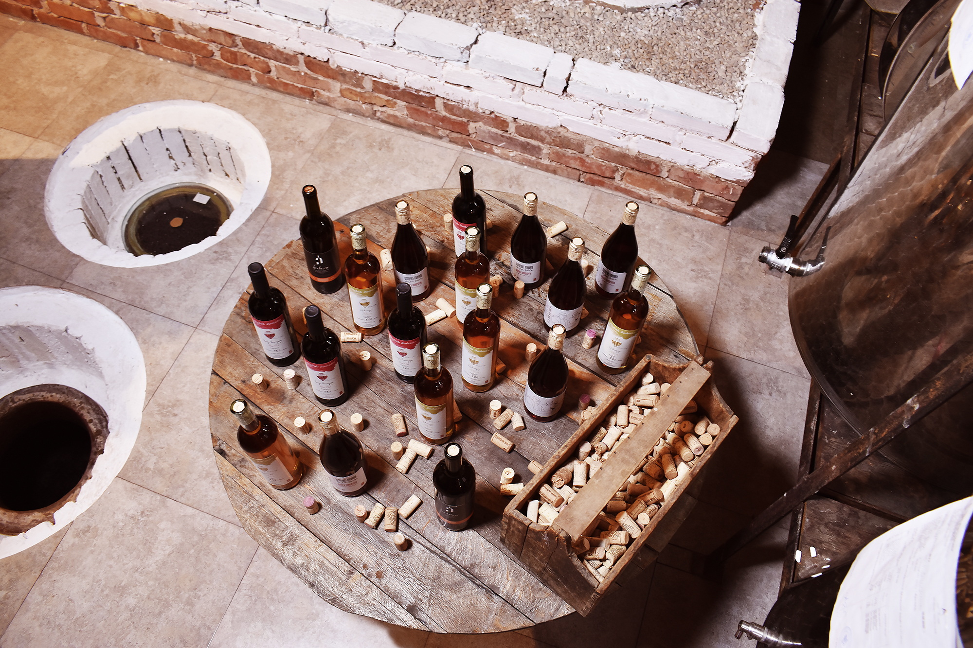 Georgian wine bottles arranged on a cellar table